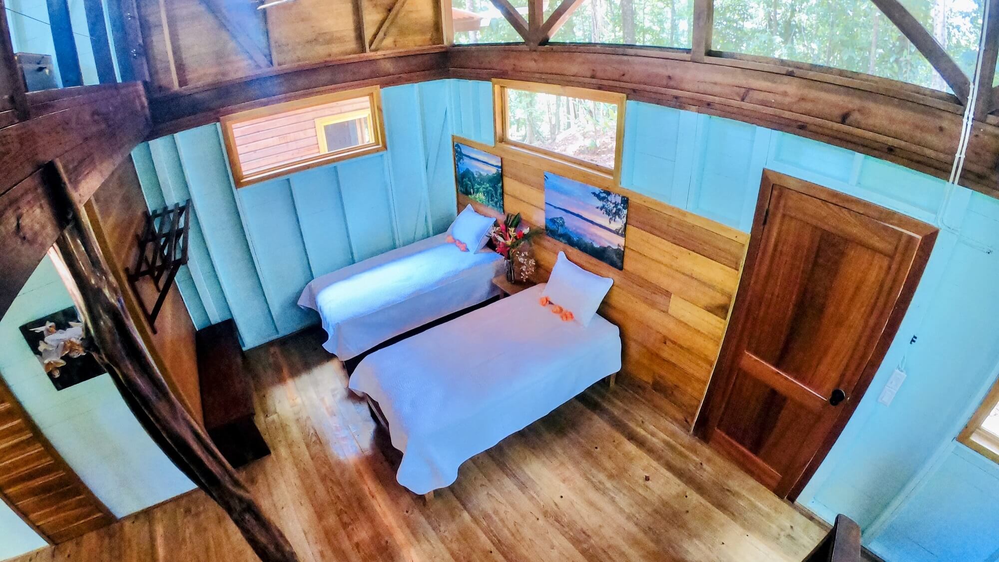 A room with two beds and wooden walls
