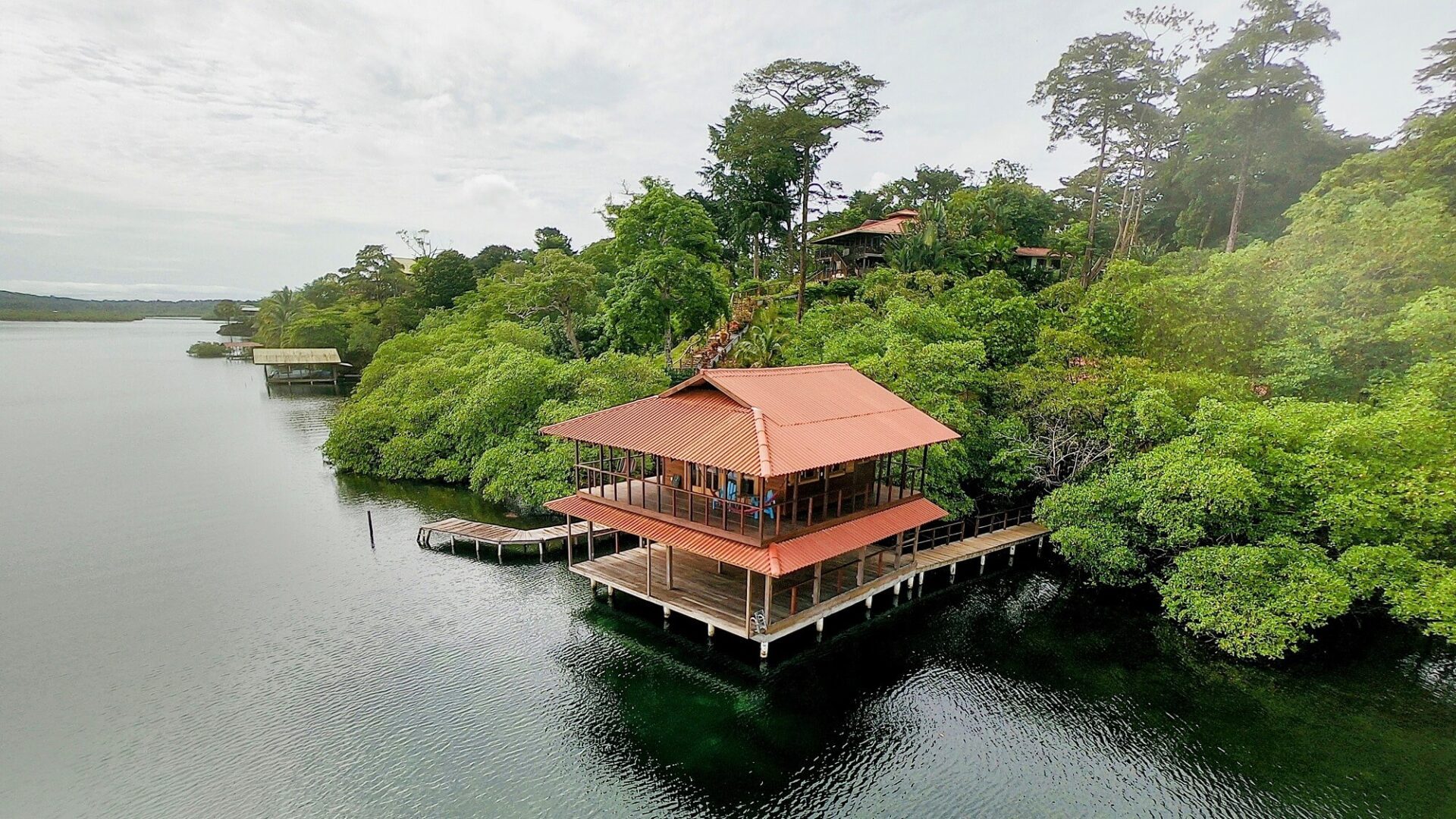 A house on stilts in the middle of water.