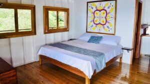 A bed room with a large painting on the wall
