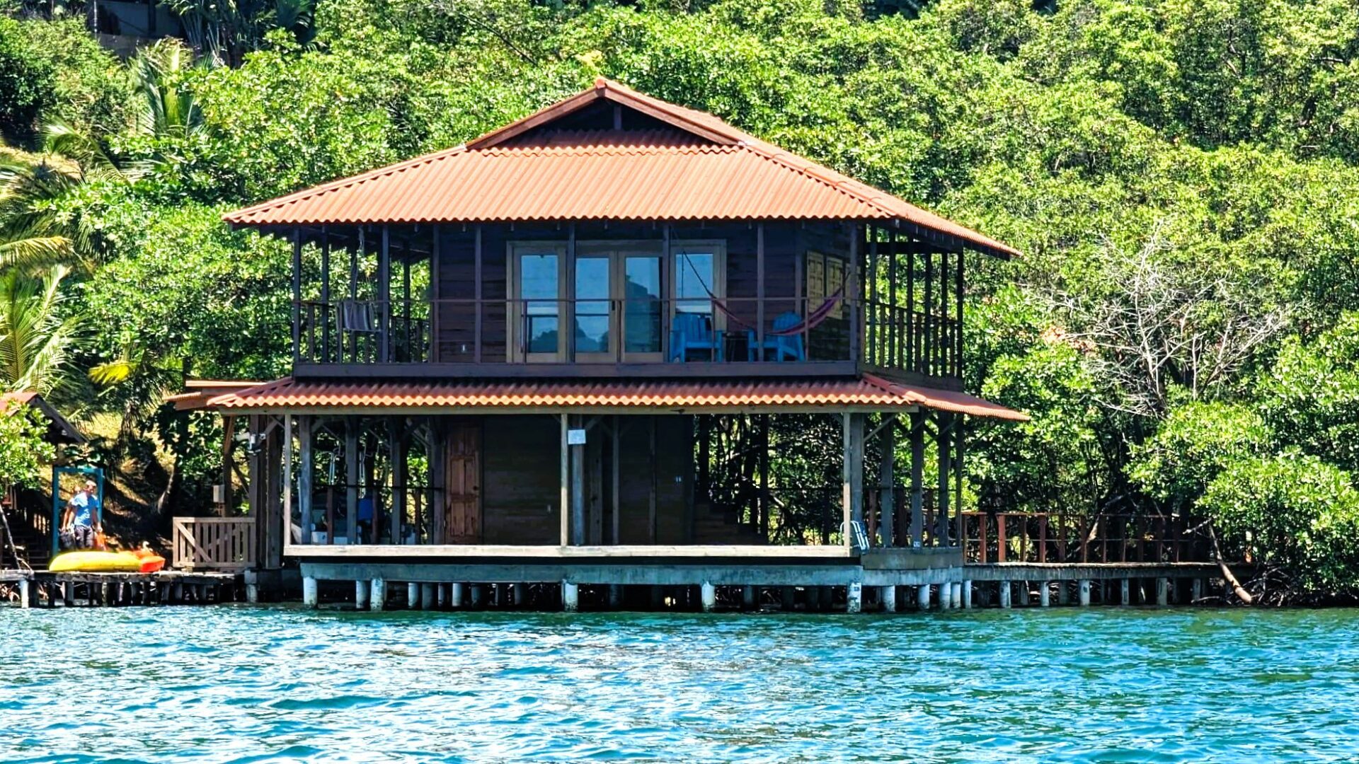 A house on stilts in the middle of water.