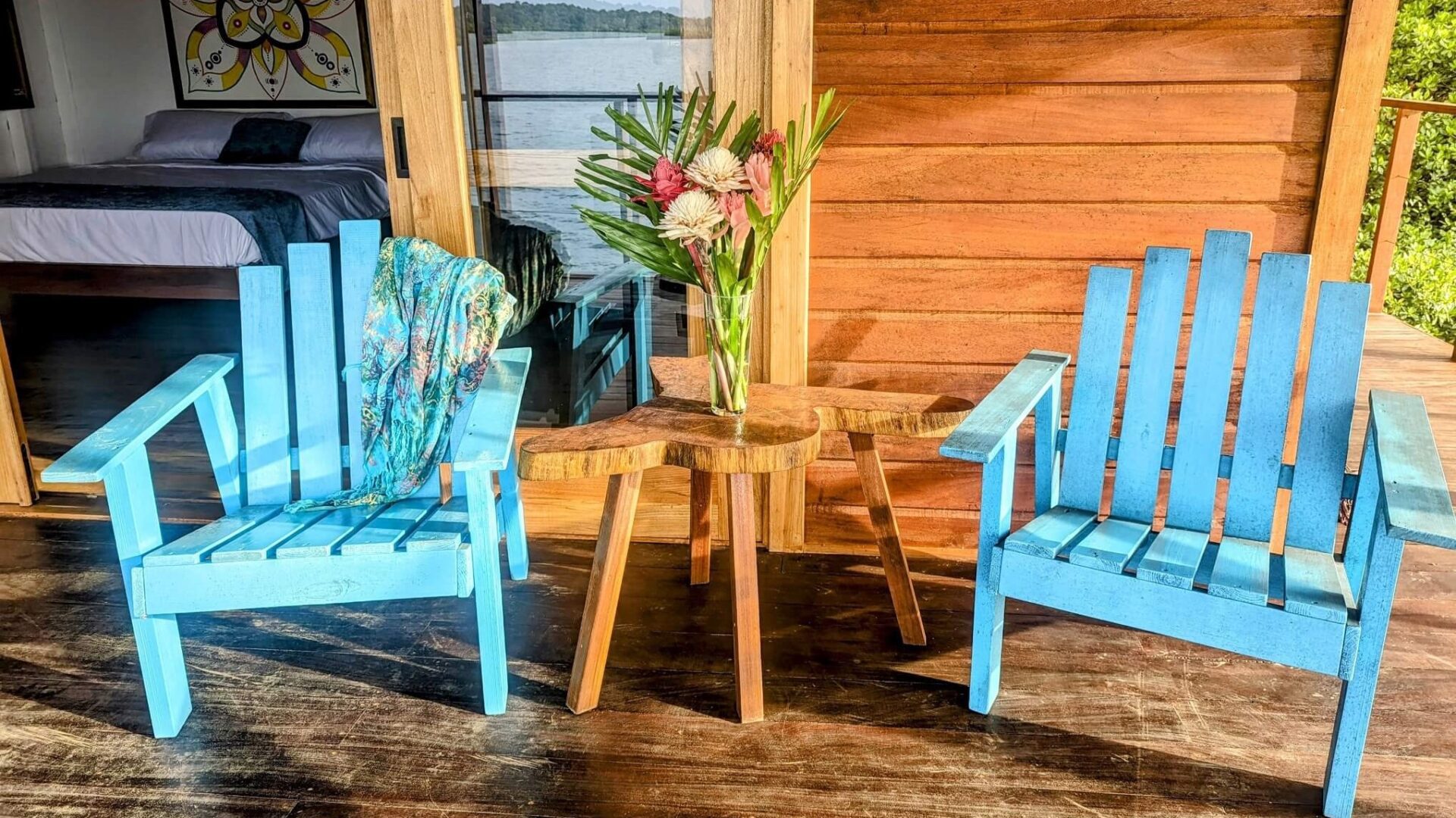 A table and two chairs with flowers on top of them.