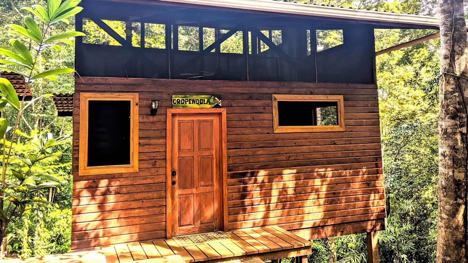 A wooden house with a porch and a door.