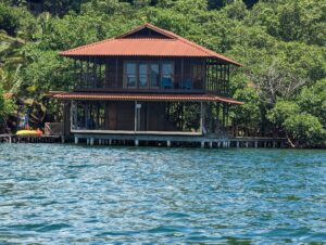 A house on stilts in the middle of water.