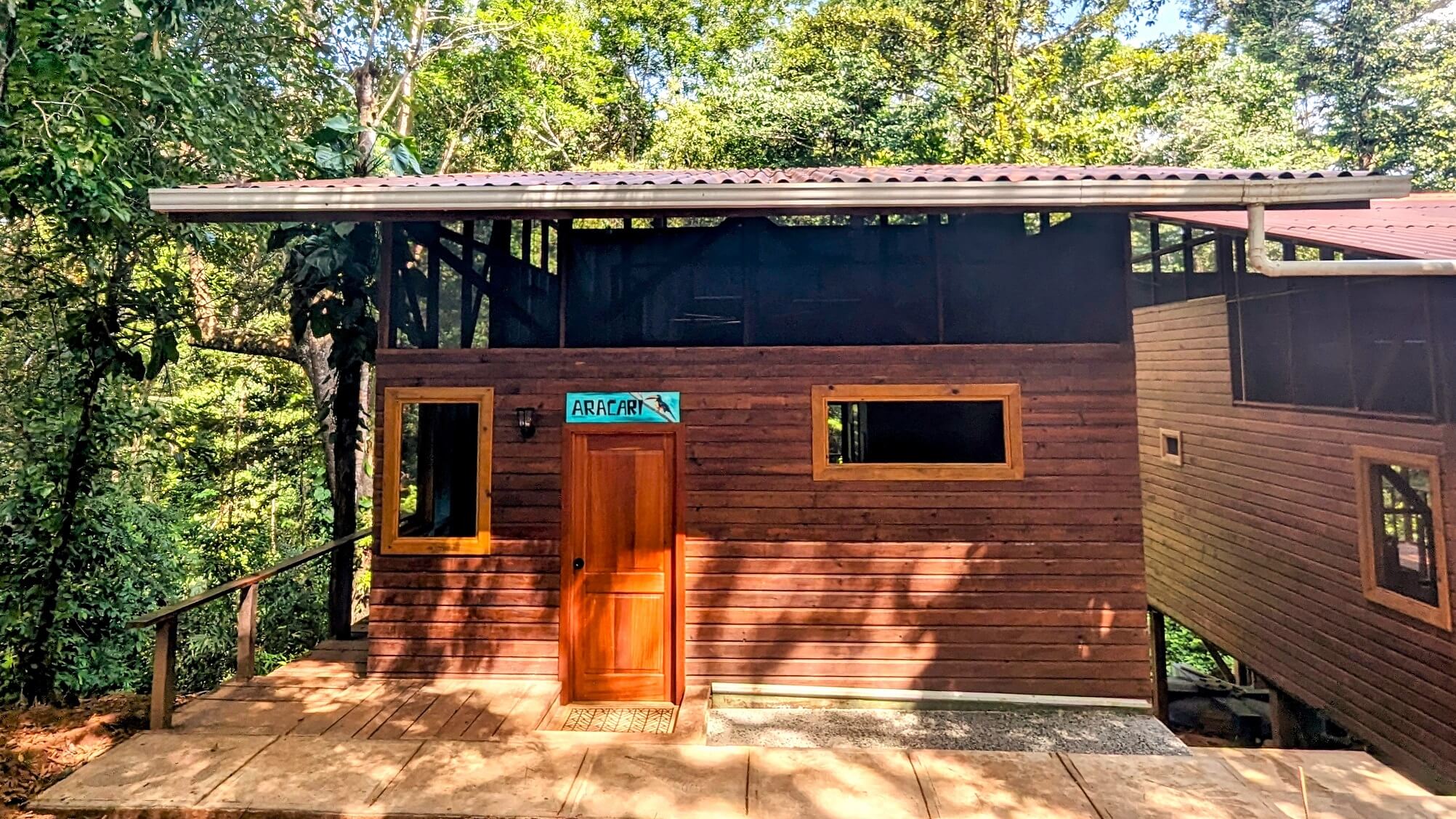 A wooden building with a door and windows.