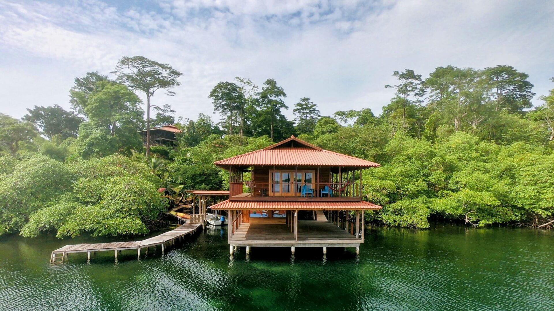 A house on stilts in the middle of a lake.