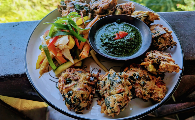 A plate of food with some vegetables and some fried ones